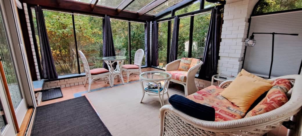 Cozy sunroom surrounded by forest & gardens