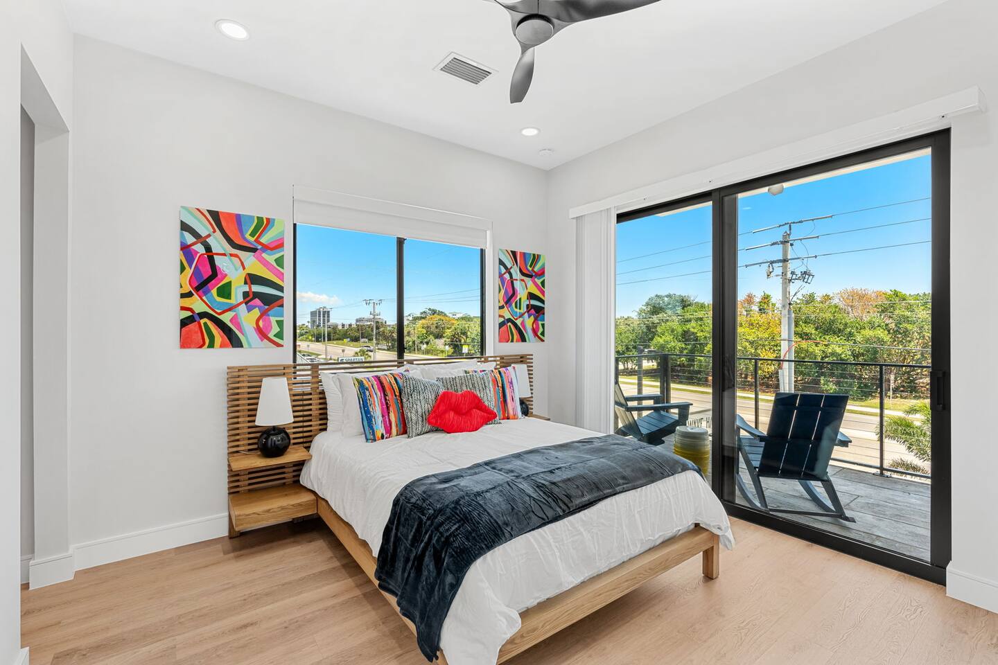 Wake up to vibrant art and natural light in peaceful bedroom 5, with a queen size bed.