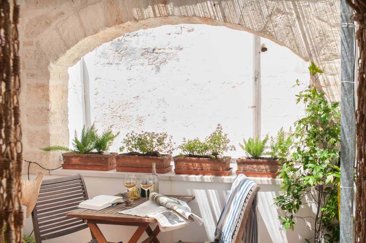 2nd floor - Shaded outdoor patio surrounded by greenery