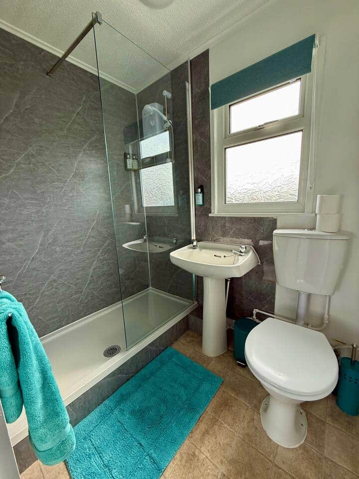Modern bathroom - four bath towels are provided with each booking.