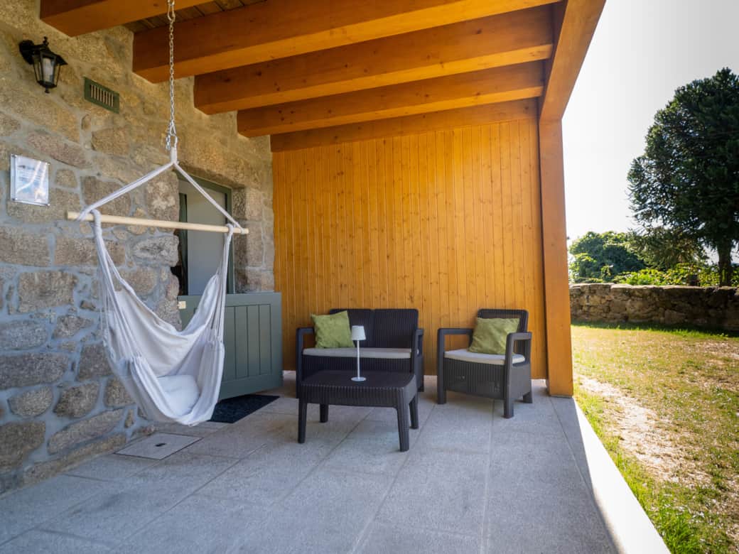 A sheltered, tranquil sitting area with a swinging hammock chair. The perfect place to relax.