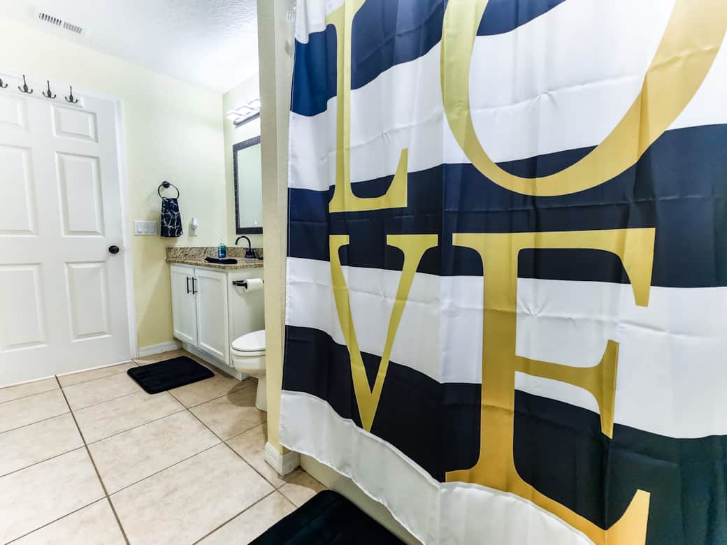 Guest bathroom includes tub, shower and has a patio door leading to pool Guest bathroom includes tub, shower and has a patio door leading to pool