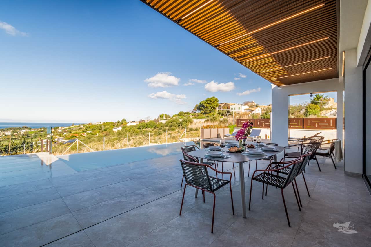 Stunning veranda for alfresco dining, with breathtaking views and a stylish seating area.