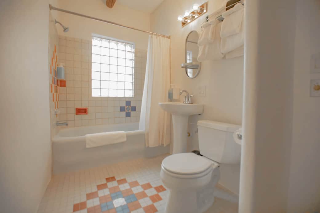 A bathtub window with lots of natural light.