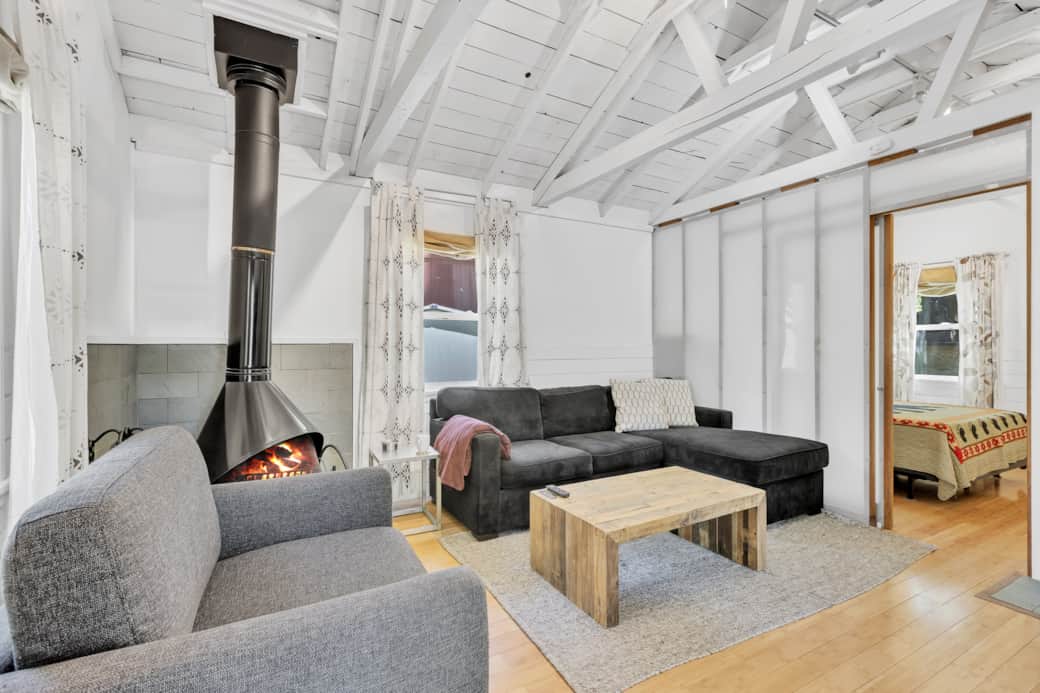 Enjoy the bright cabin living room with a cozy sofa bed, TV, and natural light. Enjoy the bright cabin living room with a cozy sofa bed, TV, and natural light.