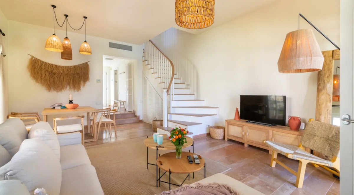 Living room with a sofa, dining table, and decorative lighting in Portville A3 032, Göcek.