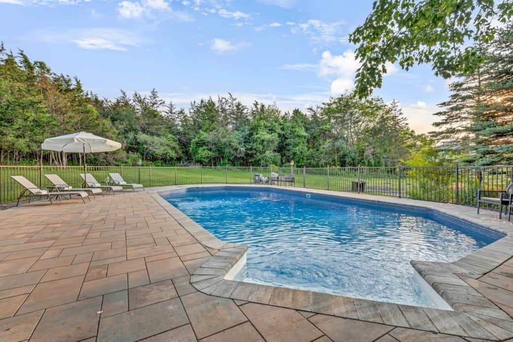 Soak up the sun or take a dip in the heated pool. Perfect for both relaxation and play with a shallow end for lounging and a deep end for diving in. Surrounded by chaise lounges, chairs, and benches, it’s your private summer sanctuary.
