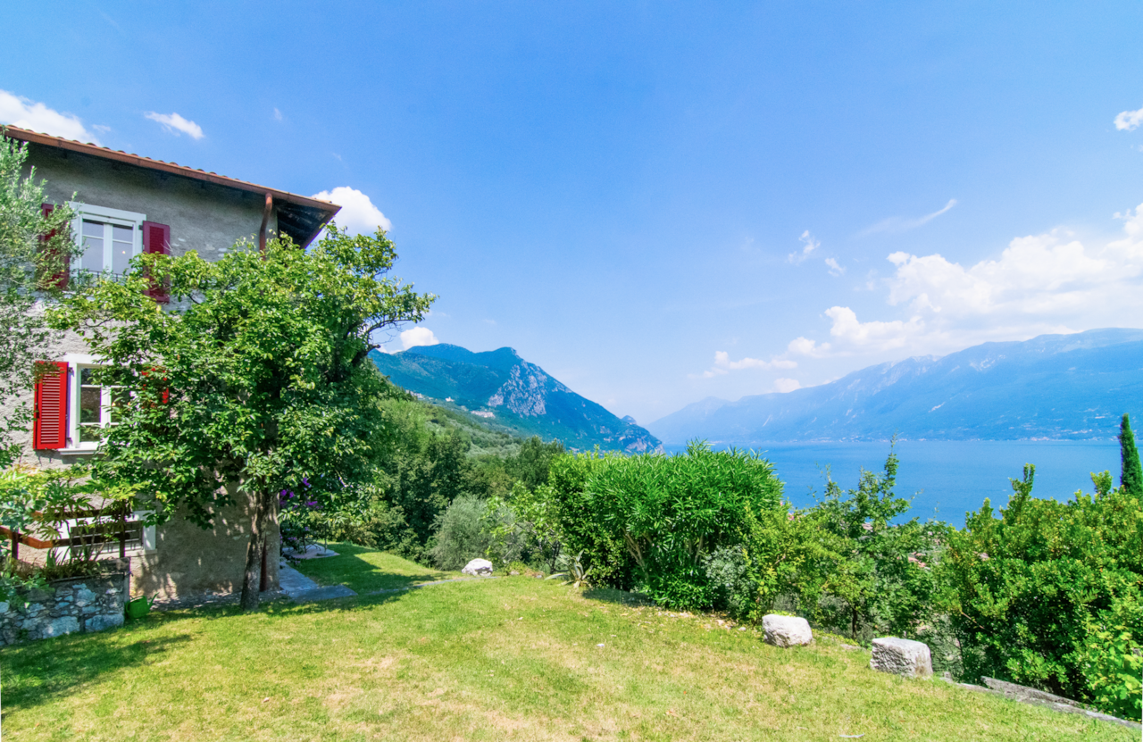 Private garden with outdoor parking area, olive trees, and nature above Toscolano Maderno on Lake Garda.