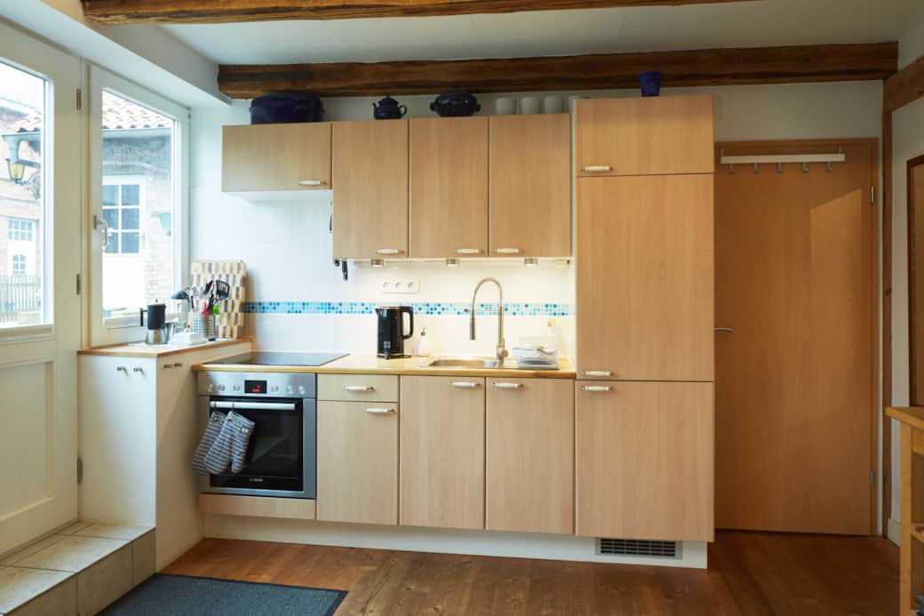 Fully equipped kitchen with induction hob, oven, fridge, dishwasher