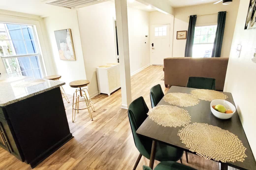 Open floor kitchen leads to a small dining area where you'll find a breakfast table plus granite countertop with 3 bar stools. 