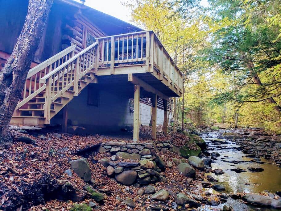 Spacious Deck w/ BBQ and chairs overlooking the brook.  Relax and listen to the sounds.