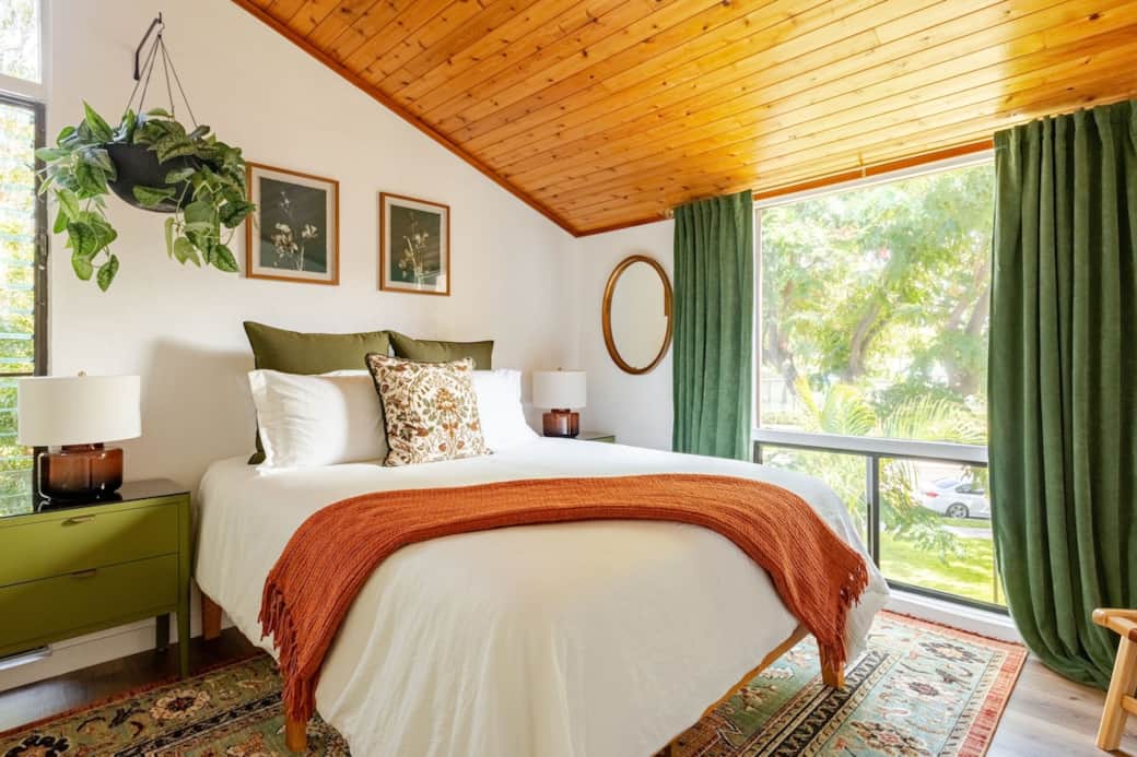 Cozy bedroom with a comfortable queen bed, sleek flat-screen TV, spacious dresser, and a generous closet for storage.