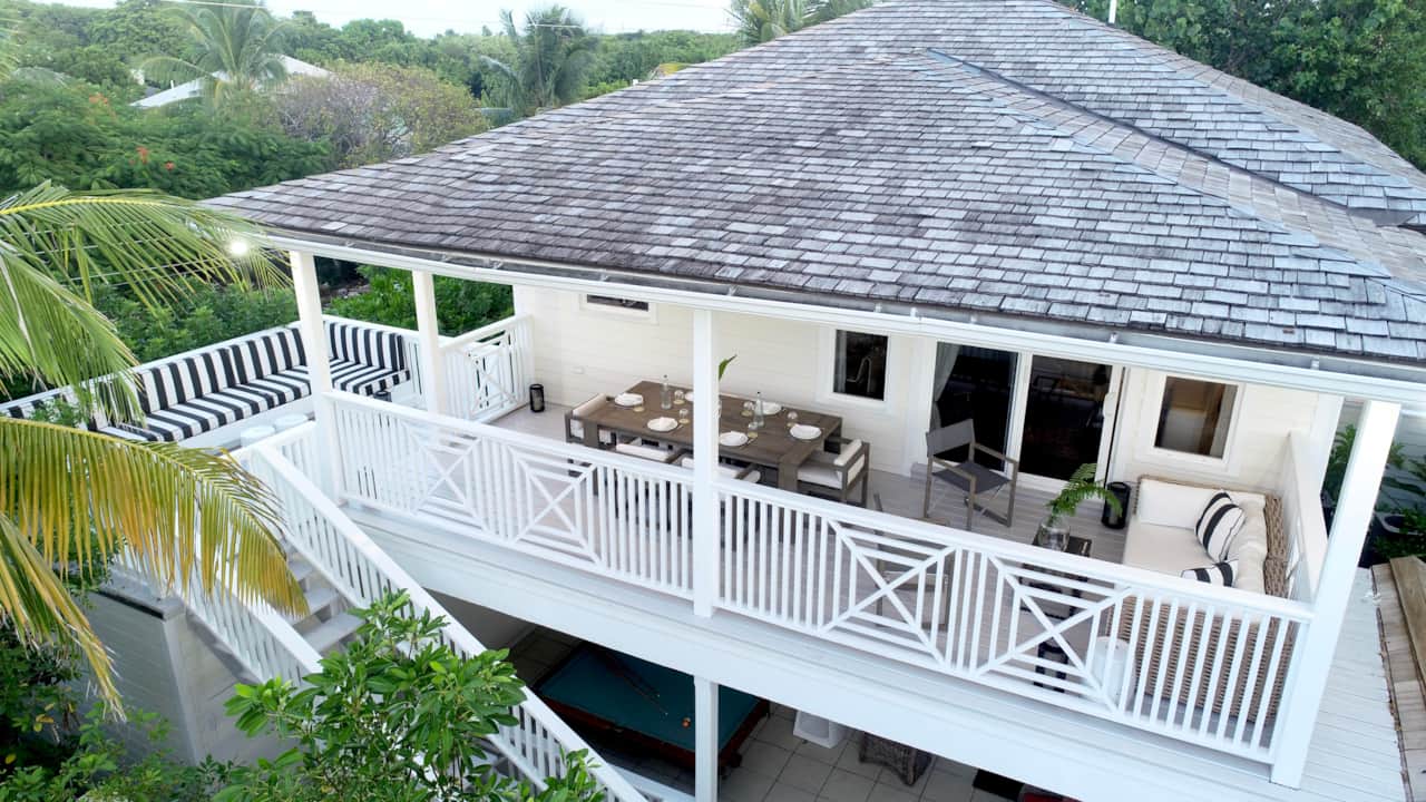 Upper-level covered deck at The Hideaway on Colebrooke Street with sea glimpses