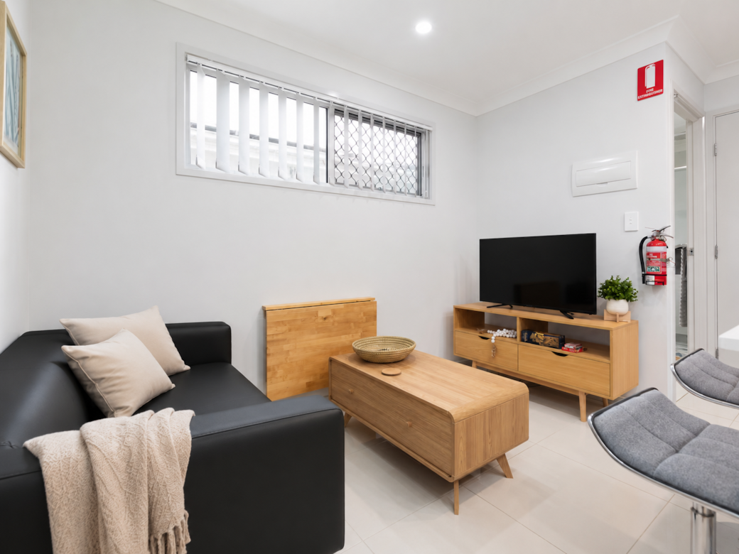 Living Area: Bright living space with comfortable seating and TV 