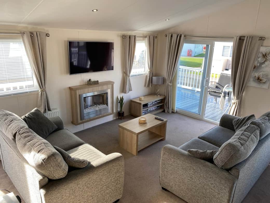 Spacious living room, with outlook to the sea.  Smart TV.  Electric fire. 