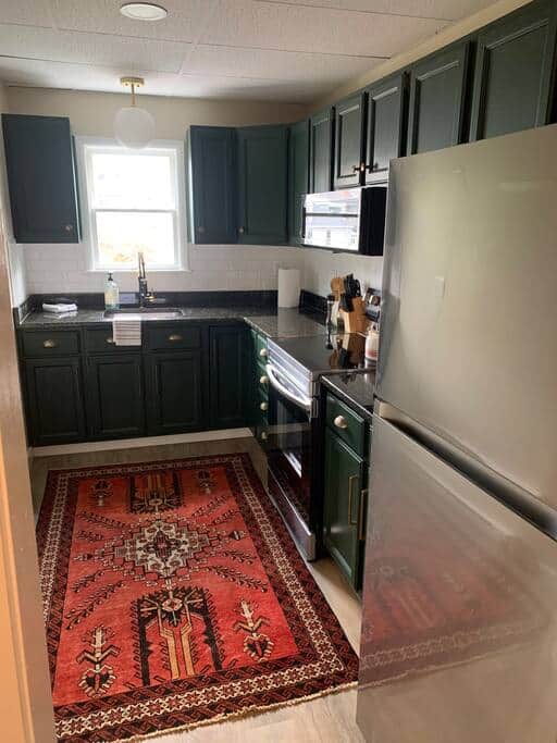Kitchen view from hallway with granite countertops, stainless steel appliances, and coffee maker. Kitchen view from hallway with granite countertops, stainless steel appliances, and coffee maker.