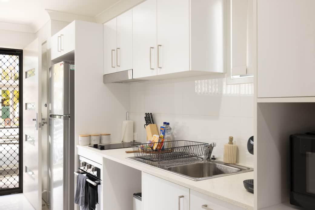 Kitchen: Sleek kitchen with ample storage, modern appliances 