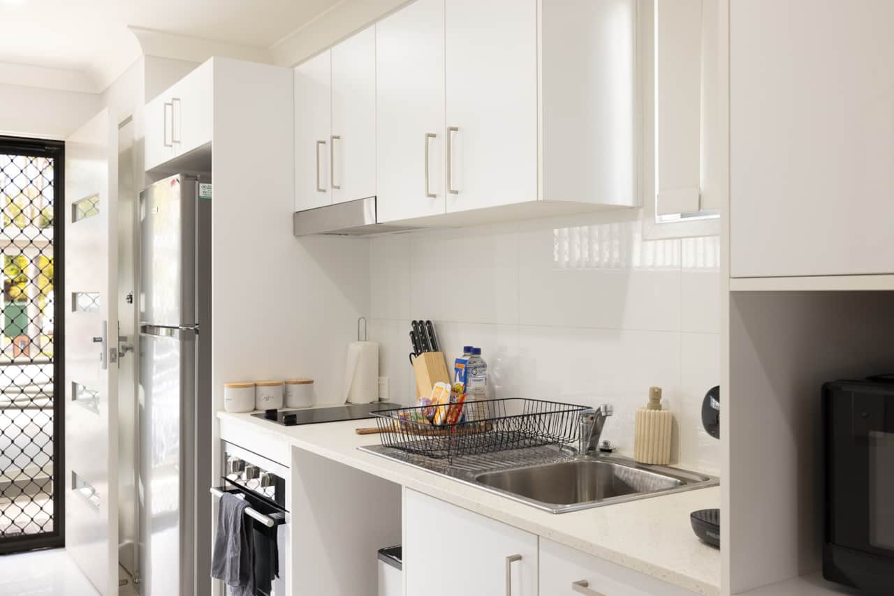 Kitchen: Sleek kitchen with ample storage, modern appliances 