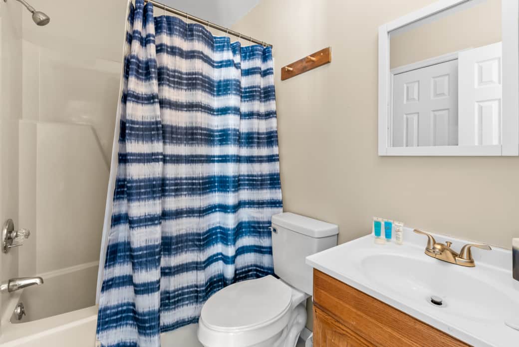 This full bathroom offers easy access with doors from both the bedroom and living room