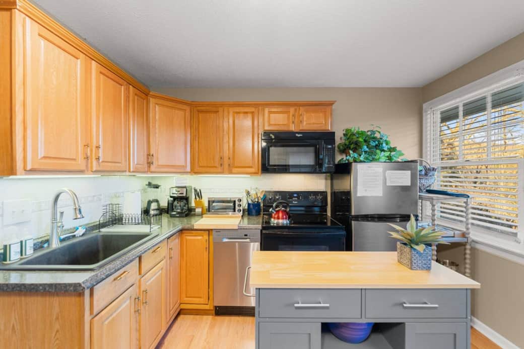 Spacious kitchen with all utilities including dishwasher, stove and refrigerator. Spacious kitchen with all utilities including dishwasher, stove and refrigerator.