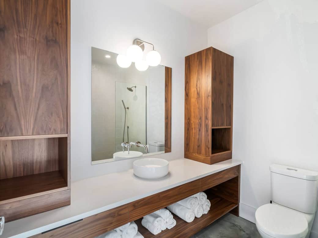 Custom walnut cabinets & walk in tiled shower in main floor bathroom