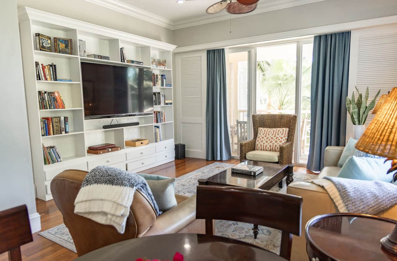 Living room TV wall with built-in bookshelves beside the balcony doors