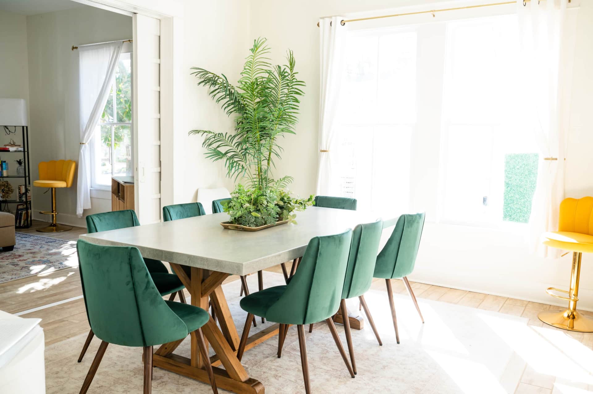 Dining table seats up to 10 with velvet chairs and stone top.