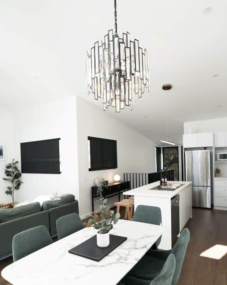 Baguette diamond cut chandelier adorns the marble dining table for elegant dining for 6.