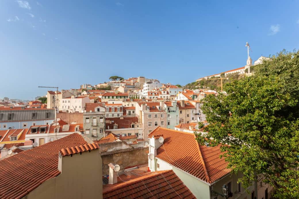 View from the kitchen - central tree in the distance is highest viewing point of the city and probably the most famous - "Miradouro da Senhora Do Monte". In the top right there is a church peering over the trees, there is "Miradoura Da Graça!