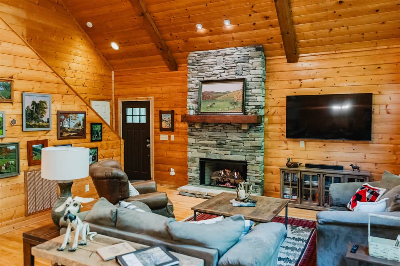 Open living room featuring new stone gas fireplace to enjoy in cold weather!
