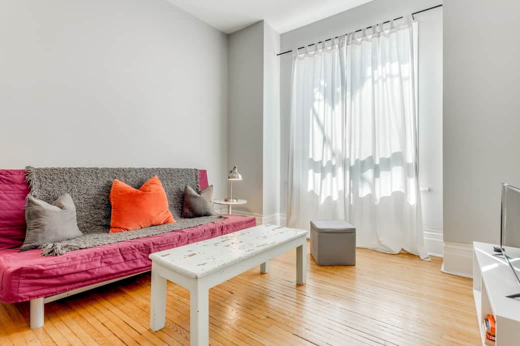 Welcoming living room in a Toronto short-term rental, bathed in natural light.