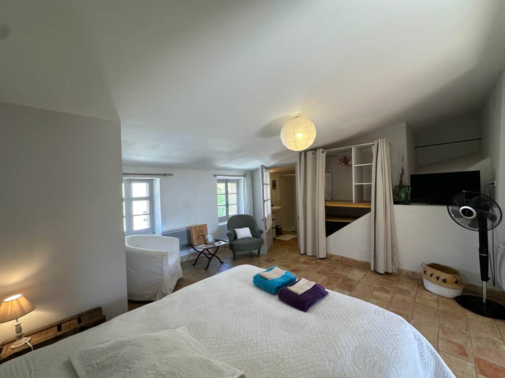 living room, fan, TV, bed area, towels, double bed, bathroom