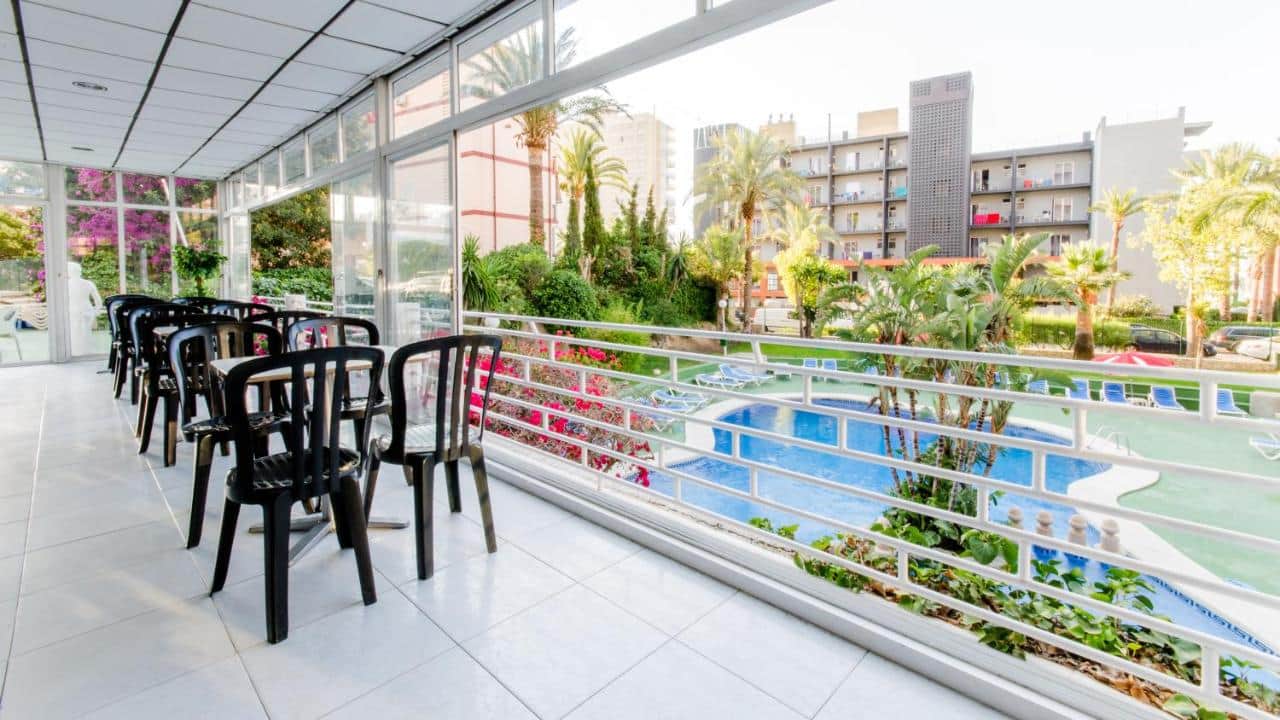 Apartment lobby area overlooking a private terrace and swimming pool