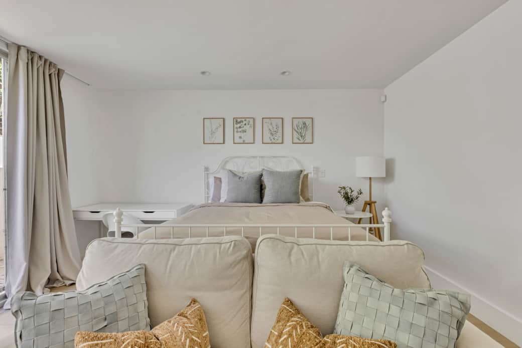 Cozy bedroom with plush bed, layered pillows, and soft neutral decor. Cozy bedroom with plush bed, layered pillows, and soft neutral decor.