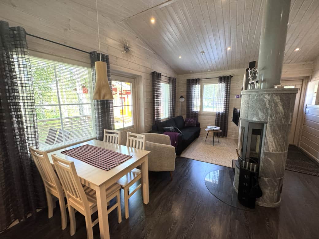 A modern yet cozy cottage with a fireplace, kitchen, sauna, and a bedroom. A modern yet cozy cottage with a fireplace, kitchen, sauna, and a bedroom.