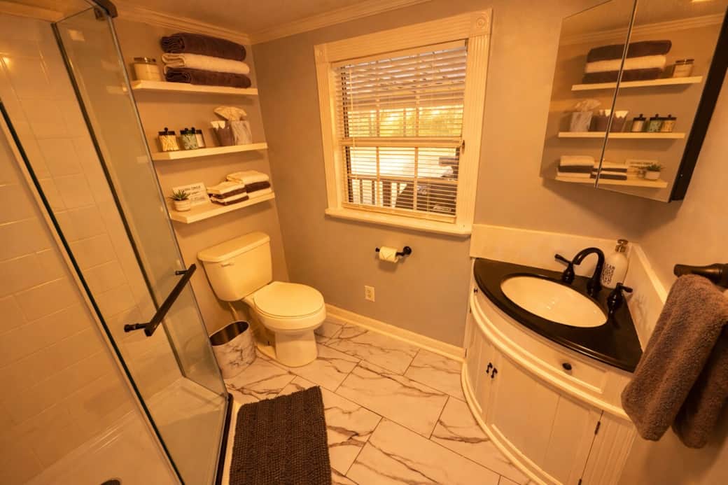 Freshly updated, this bathroom features a brand-new vanity and a new, glass-enclosed shower. Stocked with plush towels and essentials, it’s a clean, comfortable space to get ready for the day or rinse off after time on the river.