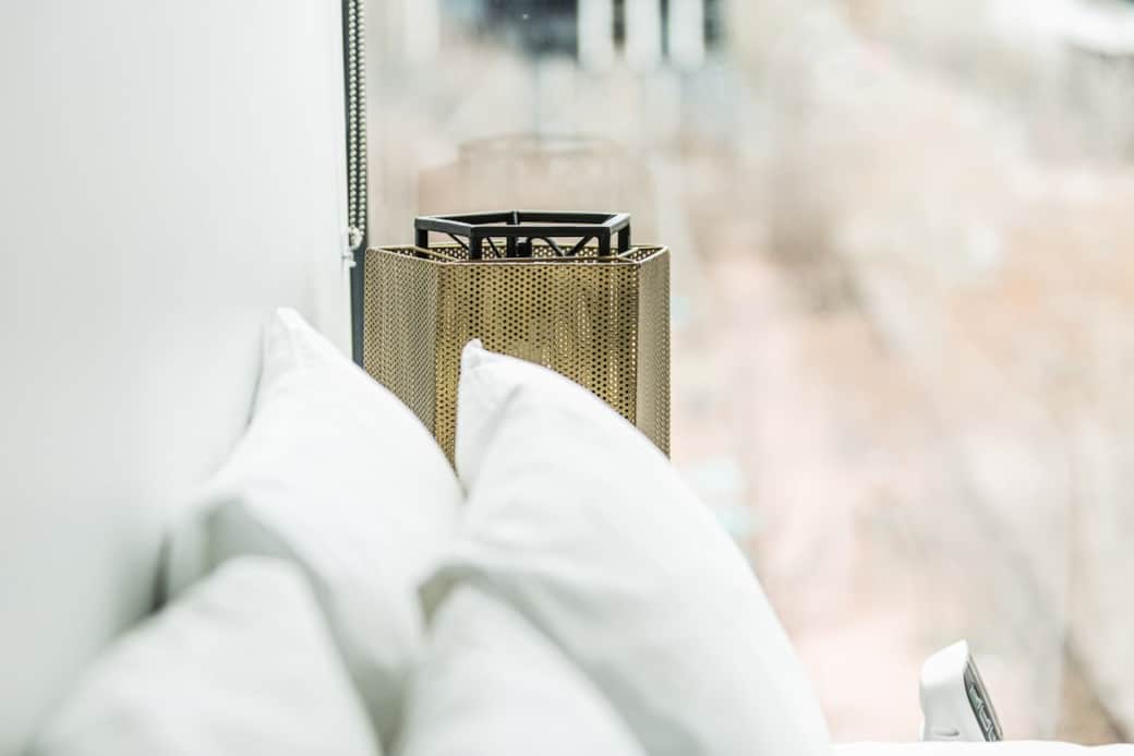 Experience serene comfort in our beautifully designed bedroom. The plush pillows and modern decorations create a relaxing atmosphere, perfect for unwinding after a day of exploring the city.