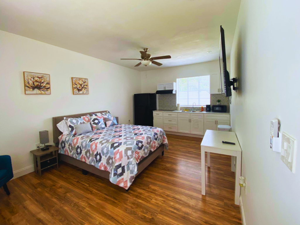 Room with nightstand, lamp, art decor, intimate dining space for two, and ceiling fan. Lakeland, FL