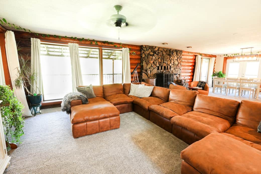 Relax on the large sectional with the cozy fireplace glowing behind you.