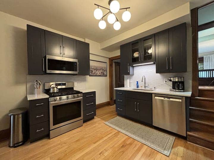 Modern, fully equipped kitchen with stainless steel appliances, sleek cabinetry.