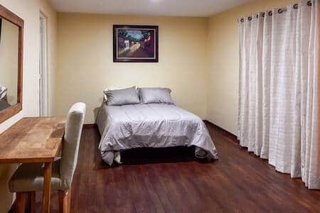 Bedroom 4: Spacious room with a comfy bed, storage, and a private ensuite bathroom.