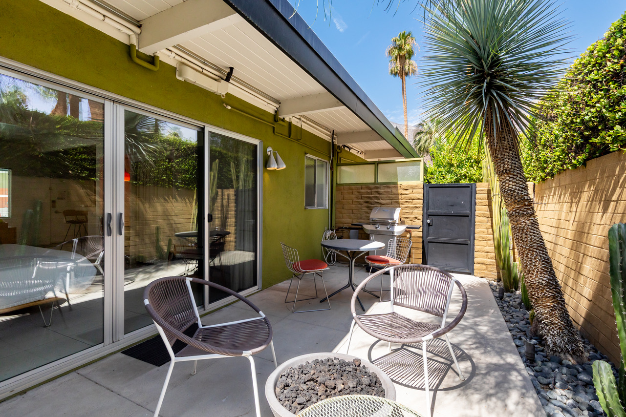 A patio area with outdoor furniture and a view of the surrounding landscape