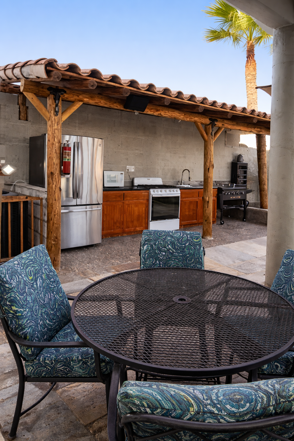 Outdoor kitchen with patio dining area