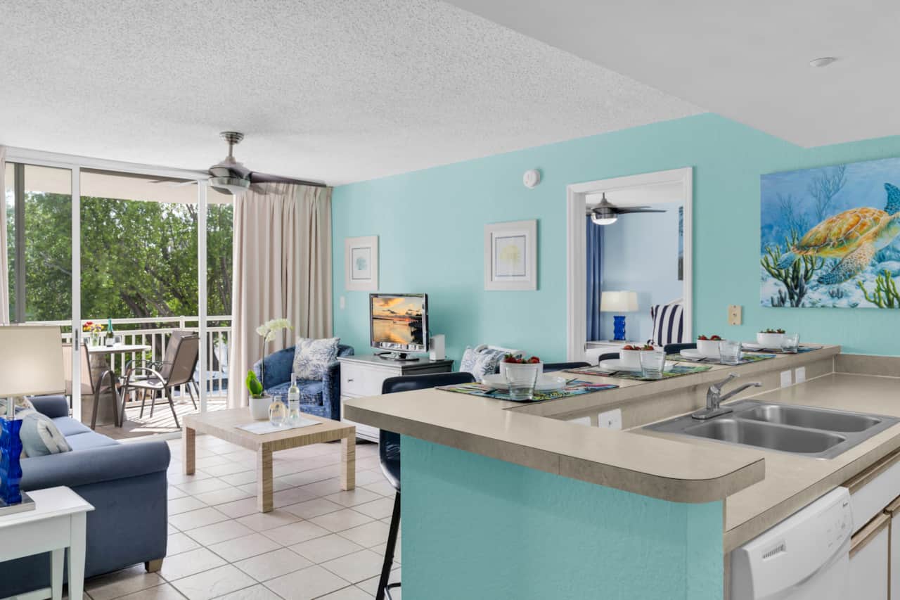 Open-concept living space with breakfast bar seating and easy access to the private balcony.