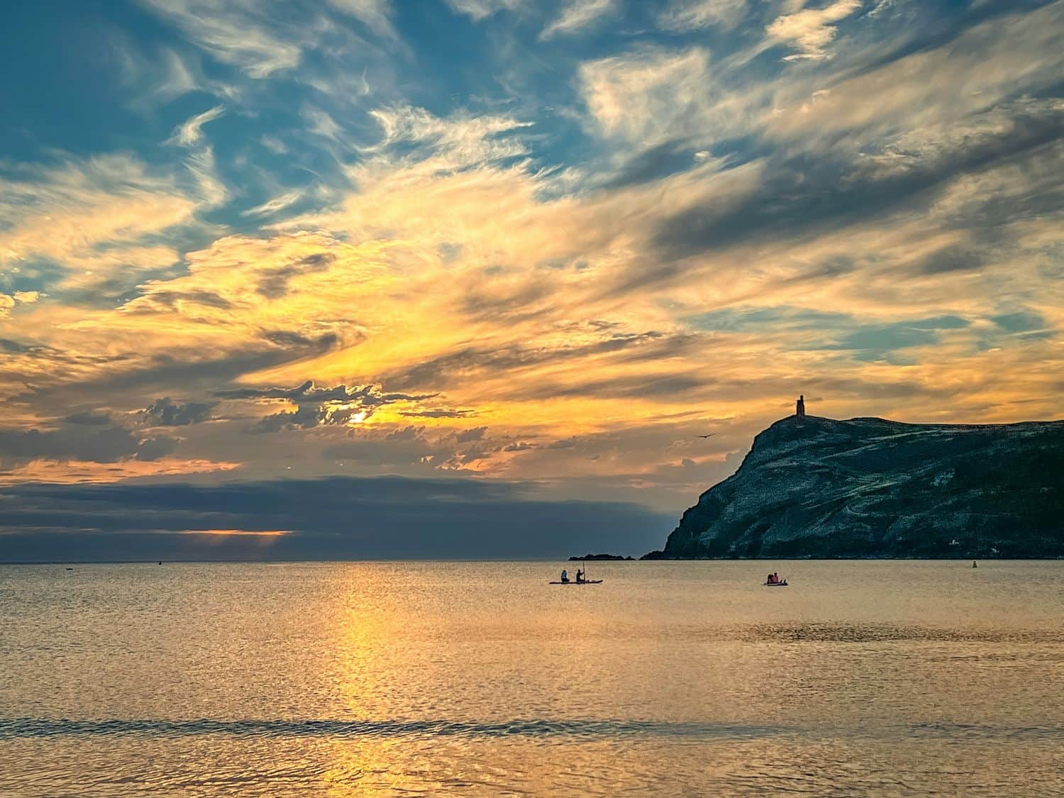 Sunset over Port Erin bay with Bradda Head on the horizon