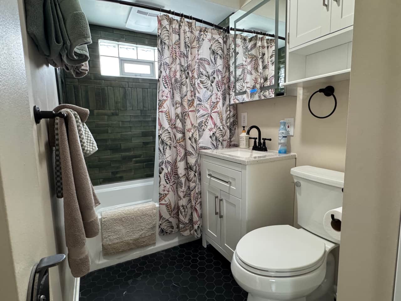 Fresh and updated bathroom with modern fixtures, tiled shower, and stylish accents.