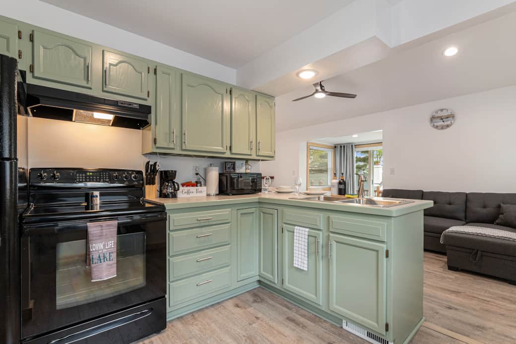 Kitchen view with coffee maker, microwave and living room view Kitchen view with coffee maker, microwave and living room view