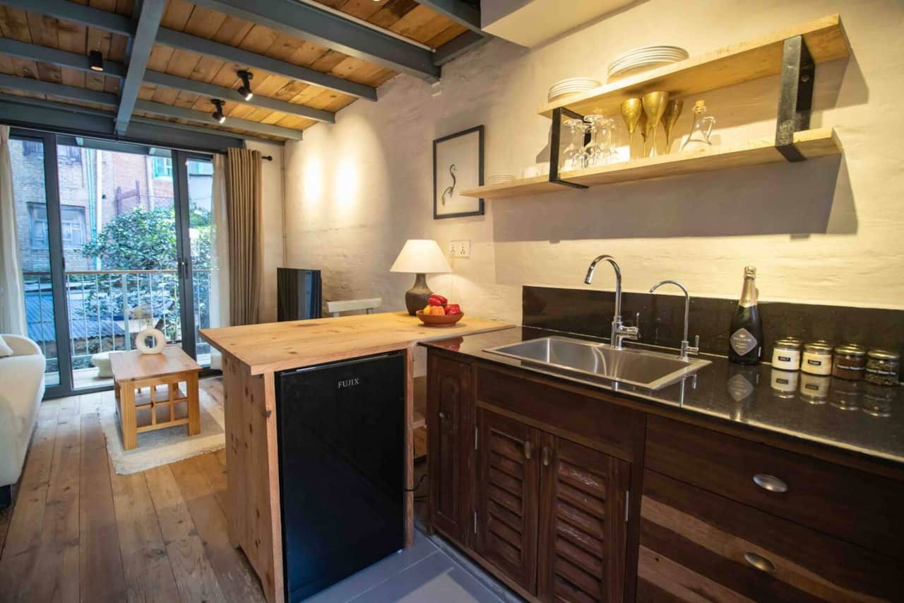Living room with sofa and TV and open kitchennette
