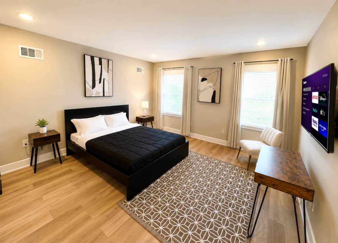 Comfortable private bedroom featuring a queen bed, attached bathroom, Roku TV, and a large closet for plenty of storage. A clean and relaxing space perfect for couples, solo travelers, or longer stays