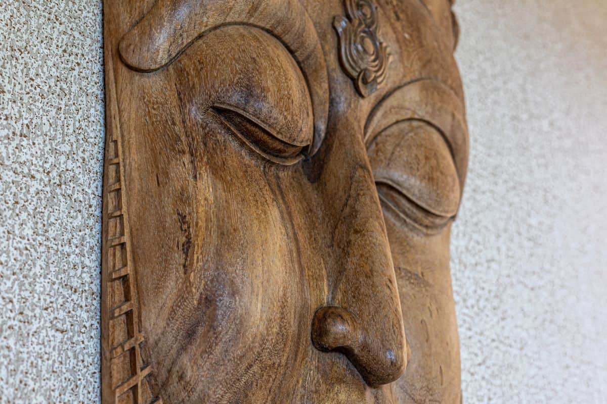 Close-up of a hand-carved wooden Buddha face, highlighting Villa Sueño’s serene and spiritual design.